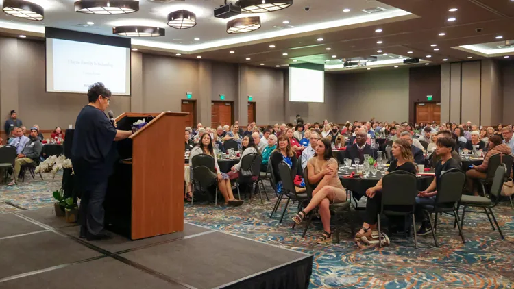 Support SVC Foundation Participants at an SVC scholarship event, listening to a speech